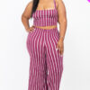 Woman wearing a purple and white striped two-piece outfit.