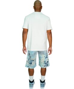 Man wearing a white polo shirt and patterned knee-length shorts.