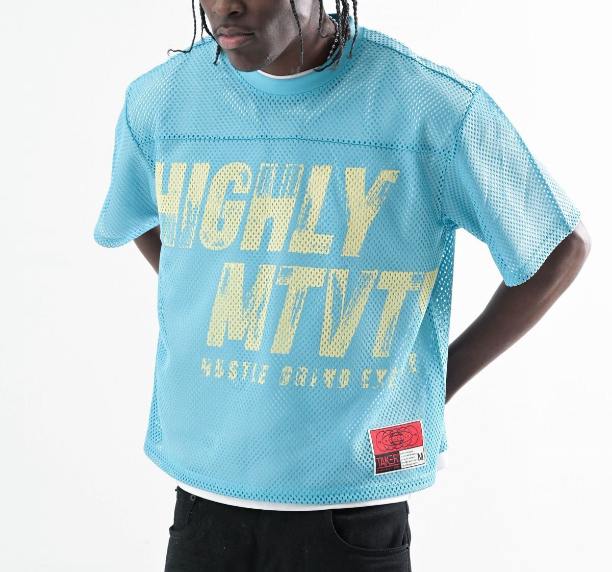 Person wearing a blue mesh shirt with bold yellow text.