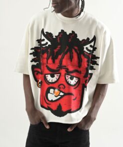 Person wearing a white t-shirt with a large red cartoon face graphic.