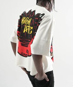 Person wearing a white oversized T-shirt with colorful graphic art on the back.