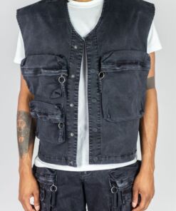 Black utility vest with multiple zippered pockets worn over a white t-shirt.