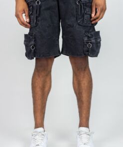 Man wearing black cargo shorts and white sneakers, standing against a plain background.
