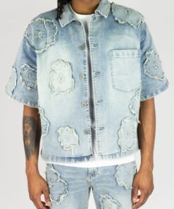 Distressed denim jacket with matching shorts, featuring frayed patches and a light wash.