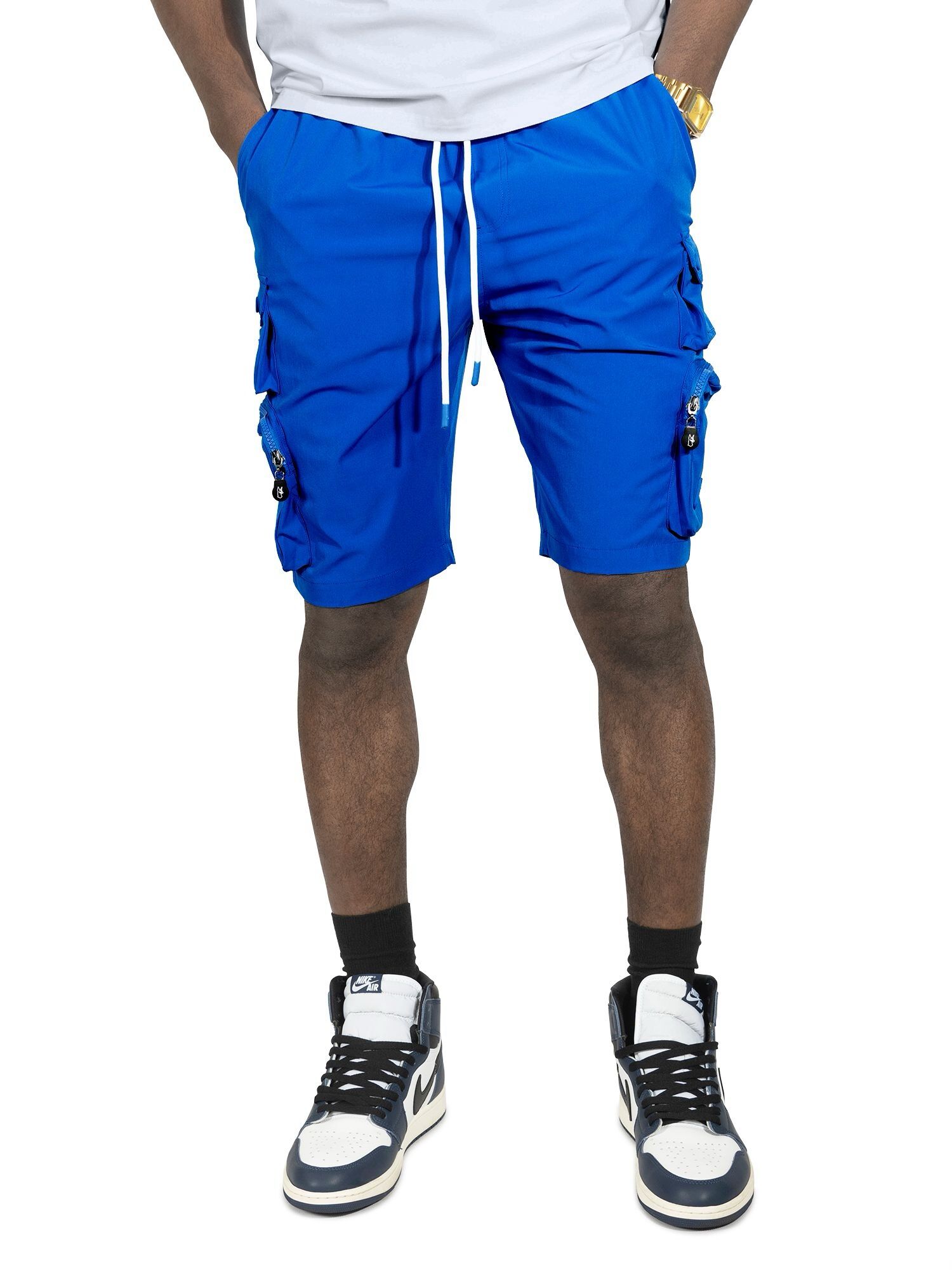 Man wearing bright blue cargo shorts and black sneakers.