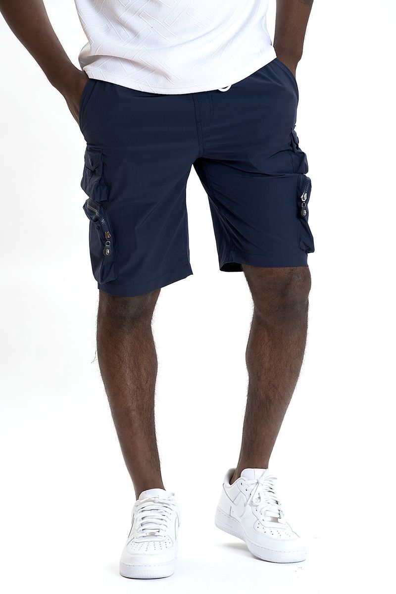 Man wearing navy blue cargo shorts and white sneakers.