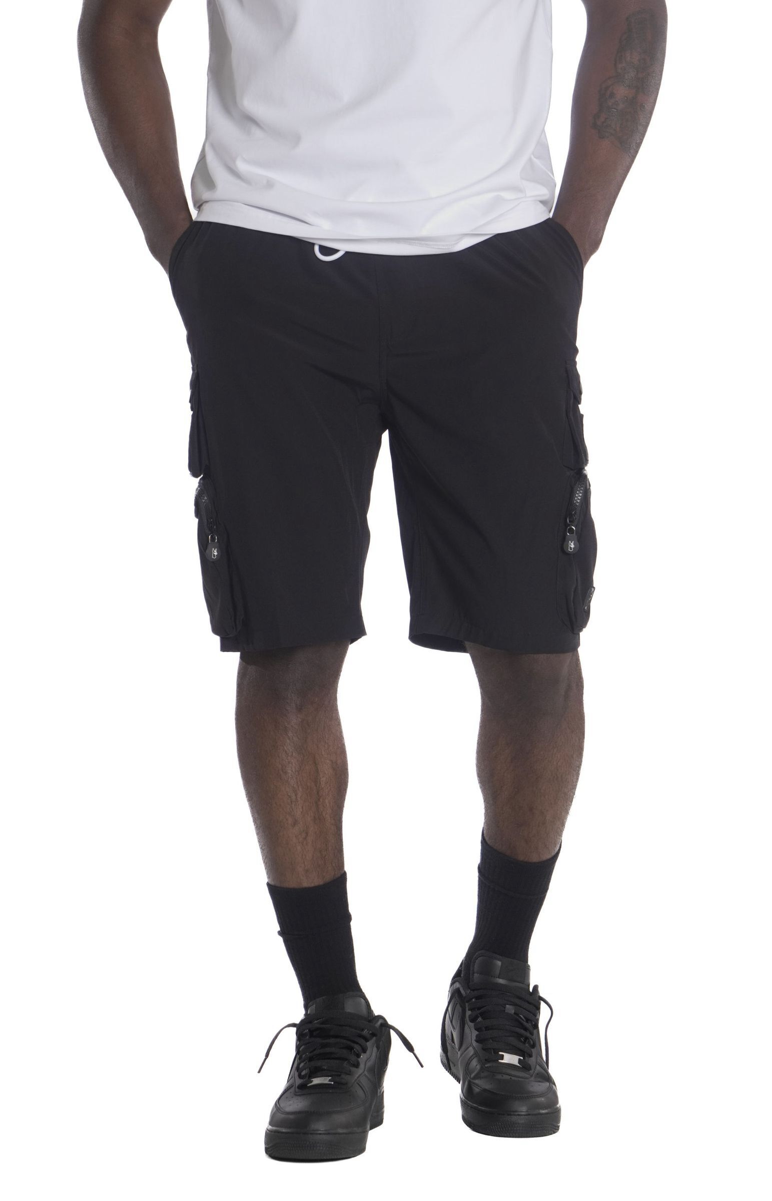 Black cargo shorts with side pockets worn by a person.